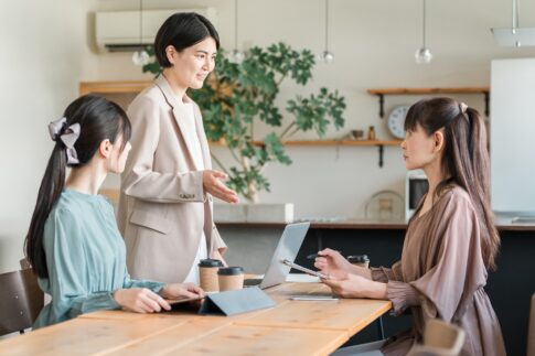 デスクで談笑する女性